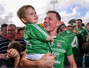 20 August 2023; Brendan Travers of Naomh Éanna celebrates with his son Ben, age 3, after victory in the Wexford County Senior Hurling Championship final match between Naomh Éanna and Oylegate-Glenbrien at Chadwicks Wexford Park in Wexford. Photo by Piaras Ó Mídheach/Sportsfile
