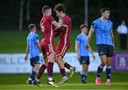 21 August 2023; Ronan Manning of Galway United celebrates with teammate Killian Brouder, left, after scoring his side's fourth goal, as Adam Verdon of UCD reacts during the Sports Direct Men’s FAI Cup Second Round match between UCD and Galway United at the UCD Bowl in Dublin. Photo by Ben McShane/Sportsfile