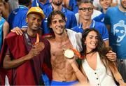 22 August 2023; Men's high jump Gold medalist, Gianmarco Tamberi of Italy, centre, and Men's high jump Bronze medalist Mutaz Essa Barshim of Qatar, left, and his wife Chiara Bontempi pose for a photograph with their medals during day four of the World Athletics Championships at the National Athletics Centre in Budapest, Hungary. Photo by Sam Barnes/Sportsfile