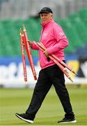 23 August 2023; Umpire Mark Hawthorne carries the stumps out to the wicket before match three of the Men's T20 International series between Ireland and India at Malahide Cricket Ground in Dublin. Photo by Seb Daly/Sportsfile