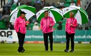 23 August 2023; Umpires, from left, Mark Hawthorne, Jareth McCready and Paul Reynolds inspect the covers and outfield as rain delays play ahead of match three of the Men's T20 International series between Ireland and India at Malahide Cricket Ground in Dublin. Photo by Seb Daly/Sportsfile