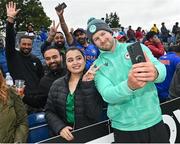 23 August 2023; Barry McCarthy of Ireland takes a selfie with spectators before match three of the Men's T20 International series between Ireland and India at Malahide Cricket Ground in Dublin. Photo by Seb Daly/Sportsfile