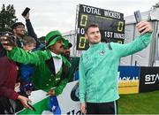 23 August 2023; Josh Little of Ireland takes a selfie with spectators before match three of the Men's T20 International series between Ireland and India at Malahide Cricket Ground in Dublin. Photo by Seb Daly/Sportsfile