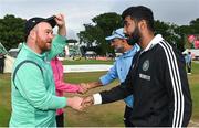 23 August 2023; Ireland captain Paul Stirling, left, and India captain Jasprit Bumrah shake hands after the abandonment of match three of the Men's T20 International series between Ireland and India at Malahide Cricket Ground in Dublin. Photo by Seb Daly/Sportsfile
