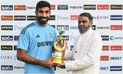 23 August 2023; India captain Jasprit Bumrah is presented with the trophy by Joy e-Bike chief executive officer Yatin Gupte after the abandonment of match three of the Men's T20 International series between Ireland and India at Malahide Cricket Ground in Dublin. Photo by Seb Daly/Sportsfile