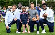 25 August 2023; Meabh Brennan, age 6, with Notre Dame players during a Notre Dame Football Clinic at Kilmacud Crokes GAA in Dublin, ahead of the Aer Lingus College Football Classic match between Notre Dame and Navy at the Aviva Stadium in Dublin. Photo by David Fitzgerald/Sportsfile