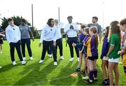 25 August 2023; Notre Dame defensive lineman Devan Houstan with young Kilmacud Crokes players during a Notre Dame Football Clinic at Kilmacud Crokes GAA in Dublin, ahead of the Aer Lingus College Football Classic match between Notre Dame and Navy at the Aviva Stadium in Dublin. Photo by David Fitzgerald/Sportsfile