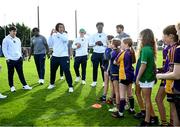 25 August 2023; Notre Dame defensive lineman Devan Houstan with young Kilmacud Crokes players during a Notre Dame Football Clinic at Kilmacud Crokes GAA in Dublin, ahead of the Aer Lingus College Football Classic match between Notre Dame and Navy at the Aviva Stadium in Dublin. Photo by David Fitzgerald/Sportsfile