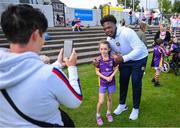 25 August 2023; Julie Coughlan, age 8, with Notre Dame defensive lineman Kobi Onyiuke during a Notre Dame Football Clinic at Kilmacud Crokes GAA in Dublin, ahead of the Aer Lingus College Football Classic match between Notre Dame and Navy at the Aviva Stadium in Dublin. Photo by David Fitzgerald/Sportsfile