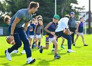 25 August 2023; Cillian Joyce, age 8, with Notre Dame wide receiver Leo Scheidler during a Notre Dame Football Clinic at Kilmacud Crokes GAA in Dublin, ahead of the Aer Lingus College Football Classic match between Notre Dame and Navy at the Aviva Stadium in Dublin. Photo by David Fitzgerald/Sportsfile