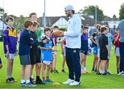 25 August 2023; Notre Dame running back Sam Assaf with young Kilmacud Crokes players during a Notre Dame Football Clinic at Kilmacud Crokes GAA in Dublin, ahead of the Aer Lingus College Football Classic match between Notre Dame and Navy at the Aviva Stadium in Dublin. Photo by David Fitzgerald/Sportsfile