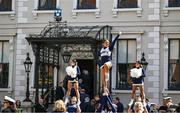 25 August 2023; Navy cheerleader Veronica Liberman is lifted by her colleagues as they perform a routine at the prestigious Ireland-US CEO Club Lunch, hosted in association with the Aer Lingus College Football Classic, at the Mansion House in Dublin. The lunch offered the perfect entreé to a weekend of fierce football competition as Notre Dame face off against the US Naval Academy at the Aviva Stadium to open the 2023 College Football season. Photo by Brendan Moran/Sportsfile