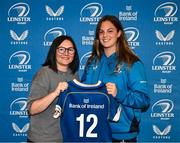 25 August 2023; Leah Tarpey is presented with her jersey by former Leinster and Ireland rugby player Yvonne Nolan during a Leinster Rugby Women's jersey presentation at Old Belvedere RFC in Dublin. Photo by Piaras Ó Mídheach/Sportsfile