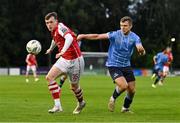 25 August 2023; Conor Carty of St Patrick's Athletic in action against Adam Wells of UCD during the SSE Airtricity Men's Premier Division match between UCD and St Patrick's Athletic at UCD Bowl in Dublin. Photo by Tyler Miller/Sportsfile