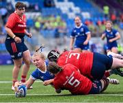 26 August 2023; Alex Connor of Leinster scores her side's second try under pressure from Aoibheann McGrath, 5, and Niamh McCarthy of Munster during the Girls Interprovincial Championship match between Leinster and Munster at Energia Park in Dublin. Photo by Piaras Ó Mídheach/Sportsfile