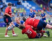 26 August 2023; Alex Connor of Leinster scores her side's second try under pressure from Aoibheann McGrath, 5, and Niamh McCarthy of Munster during the Girls Interprovincial Championship match between Leinster and Munster at Energia Park in Dublin. Photo by Piaras Ó Mídheach/Sportsfile