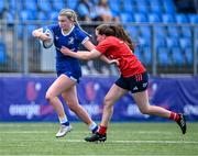 26 August 2023; Clara Dunne of Leinster in action against Lily Byrne of Munster during the Girls Interprovincial Championship match between Leinster and Munster at Energia Park in Dublin. Photo by Piaras Ó Mídheach/Sportsfile