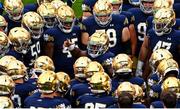 26 August 2023; Notre Dame defensive lineman Nana Osafo-Mensah, centre, gives a pep-talk to teammates before the Aer Lingus College Football Classic match between Notre Dame and Navy Midshipmen at the Aviva Stadium in Dublin. Photo by Ben McShane/Sportsfile