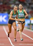 26 August 2023; Sharlene Mawdsley of Ireland, left, takes the baton from Kelly McGrory while competing in the women's 4x400m relay heats during day eight of the World Athletics Championships at the National Athletics Centre in Budapest, Hungary. Photo by Sam Barnes/Sportsfile