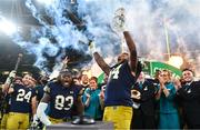 26 August 2023; Notre Dame offensive lineman Blake Fisher #54, right, lifts the Keough - Naughton College Football Ireland trophy after the Aer Lingus College Football Classic match between Notre Dame and Navy Midshipmen at the Aviva Stadium in Dublin. Photo by Ben McShane/Sportsfile