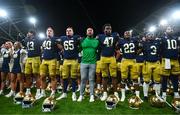 26 August 2023; Notre Dame head coach Marcus Freeman, centre, celebrates with his players after their side's victory in the Aer Lingus College Football Classic match between Notre Dame and Navy Midshipmen at the Aviva Stadium in Dublin. Photo by Ben McShane/Sportsfile