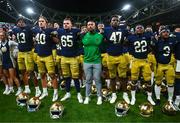 26 August 2023; Notre Dame players and head coach Marcus Freeman, centre, celebrate after the Aer Lingus College Football Classic match between Notre Dame and Navy Midshipmen at the Aviva Stadium in Dublin. Photo by Ben McShane/Sportsfile