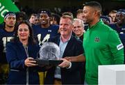 26 August 2023; Notre Dame head coach Marcus Freeman is presented with his trophy by Minister for Tourism, Culture, Arts, Gaeltacht, Sport and Media, Catherine Martin TD, left, and Minister for Finance Michael McGrath TD after the Aer Lingus College Football Classic match between Notre Dame and Navy Midshipmen at the Aviva Stadium in Dublin. Photo by Brendan Moran/Sportsfile