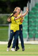27 August 2023; Mollie Devine of Fox Lodge, left, is congratulated by teammate Laura Allen after running out Merrion batter Rachel Delaney during the Arachas Women's All-Ireland T20 Cup Final match between Merrion and Fox Lodge at Malahide Cricket Ground in Dublin. Photo by Seb Daly/Sportsfile