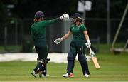 27 August 2023; Merrion batter Leah Paul, right, is congratulated by teammate Polly Inglis after bringing up her century during the Arachas Women's All-Ireland T20 Cup Final match between Merrion and Fox Lodge at Malahide Cricket Ground in Dublin. Photo by Seb Daly/Sportsfile