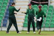 27 August 2023; Merrion wicketkeeper Polly Inglis, centre, is congratulated by teammate Rebecca Stokell, left, after running out Fox Lodge batter Lucy Neely during the Arachas Women's All-Ireland T20 Cup Final match between Merrion and Fox Lodge at Malahide Cricket Ground in Dublin. Photo by Seb Daly/Sportsfile