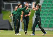 27 August 2023; Merrion bowler Rachel Delaney, left, is congratulated by teammate Ally Boucher after dismissing Fox Lodge's Sarah Black during the Arachas Women's All-Ireland T20 Cup Final match between Merrion and Fox Lodge at Malahide Cricket Ground in Dublin. Photo by Seb Daly/Sportsfile