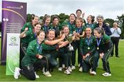 27 August 2023; Merrion captain Niamh MacNulty, second from left, and teammates celebrate with the trophy after their side's victory in the Arachas Women's All-Ireland T20 Cup Final match between Merrion and Fox Lodge at Malahide Cricket Ground in Dublin. Photo by Seb Daly/Sportsfile