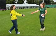27 August 2023; Merrion captain Niamh MacNulty, right, and Fox Lodge captain Kara Bates shake hands after the Arachas Women's All-Ireland T20 Cup Final match between Merrion and Fox Lodge at Malahide Cricket Ground in Dublin. Photo by Seb Daly/Sportsfile