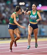 27 August 2023; Sharlene Mawdsley of Ireland takes the baton from teammate Kelly McGrory as they compete in the Women's 4x400m Relay final during day nine of the World Athletics Championships at the National Athletics Centre in Budapest, Hungary. Photo by Sam Barnes/Sportsfile