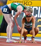 27 August 2023; Sharlene Mawdsley of Ireland is consoled by teammate Roisin Harrison, left, after finishing 8th in the Women's 4x400m Relay final during day nine of the World Athletics Championships at the National Athletics Centre in Budapest, Hungary. Photo by Sam Barnes/Sportsfile
