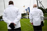 27 August 2023; The umpires stand for the National Anthem before the Donegal County Senior Club Football Championship match between Naomh Conaill and St Eunan's at Davy Brennan Memorial Park in Gortnamucklagh, Donegal. Photo by Ramsey Cardy/Sportsfile