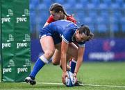 26 August 2023; Niamh Murphy of Leinster scores her side's fifth try, under pressure from Aoibheann McGrath of Munster, during the Girls Interprovincial Championship match between Leinster and Munster at Energia Park in Dublin. Photo by Piaras Ó Mídheach/Sportsfile