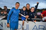29 August 2023; Sam Prendergast with supporters Harry, age 5, Millie, age 7, and Ross Mayberry after a Leinster rugby open training session at Clontarf RFC in Dublin. Photo by David Fitzgerald/Sportsfile