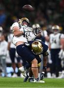 26 August 2023; Navy Midshipmen defensive tackle RJ Davis #46 is tackled by Notre Dame cornerback Cam Hart #5 during the Aer Lingus College Football Classic match between Notre Dame and Navy Midshipmen at the Aviva Stadium in Dublin. Photo by Ben McShane/Sportsfile