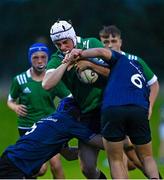 30 August 2023; Cillian McElwee of South East is tackled by Nathan Byrne, left, and Conor Wolfe of Metro during the BearingPoint Shane Horgan Cup match between South East and Metro at Cill Dara RFC in Kildare. Photo by Tyler Miller/Sportsfile