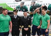 31 August 2023; Ireland players, from left, Tadhg Furlong, Robbie Henshaw and Josh van der Flier pose for a photograph with Aer Lingus pilots Caolan Flanagan and Ruairi Farrell at Dublin Airport ahead of Ireland's flight to France for the 2023 Rugby World Cup. Photo by Harry Murphy/Sportsfile