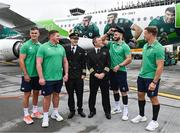 31 August 2023; Ireland players, from left, Jonathan Sexton, Tadhg Furlong, Robbie Henshaw and Josh van der Flier pose for a photograph with Aer Lingus pilots Caolan Flanagan and Ruairi Farrell at Dublin Airport ahead of Ireland's flight to France for the 2023 Rugby World Cup. Photo by Harry Murphy/Sportsfile