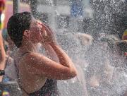 2 September 2023; A competitor takes a shower after finishing the 103rd Jones Engineering Liffey Swim organised by Leinster Open Sea. Photo by Ray McManus/Sportsfile
