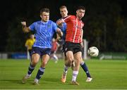 6 September 2023; Cian Kavanagh of Derry City in action against Adam Wells, left, and Jack Keaney of UCD during the SSE Airtricity Men's Premier Division match between UCD and Derry City at UCD Bowl in Dublin. Photo by Ben McShane/Sportsfile