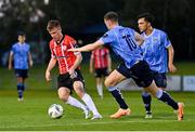6 September 2023; Brandon Kavanagh of Derry City in action against Ciaran Behan, 10, and Sean Brennan of UCD during the SSE Airtricity Men's Premier Division match between UCD and Derry City at UCD Bowl in Dublin. Photo by Ben McShane/Sportsfile