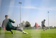8 September 2023; Jonathan Afolabi has a shot on goalkeeper Mark Travers during a Republic of Ireland training session at the FAI National Training Centre in Abbotstown, Dublin. Photo by Stephen McCarthy/Sportsfile