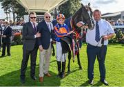 9 September 2023; Trainer Aidan O'Brien, left, owner Michael Tabor, second from left, and jockey Ryan Moore after winning the Royal Bahrain Irish Champion Stakes with Auguste Rodin during day one of the Irish Champions Festival at Leopardstown Racecourse in Dublin. Photo by Seb Daly/Sportsfile