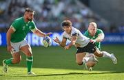 9 September 2023; Gabriel Rupanu of Romania offloads as he is tackled by Jeremy Loughman of Ireland, right, during the 2023 Rugby World Cup Pool B match between Ireland and Romania at Stade de Bordeaux in Bordeaux, France. Photo by Harry Murphy/Sportsfile