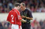 3 July 2004; Sean O' Brien, Cork, is booked by referee Seamus McCormack. Bank of Ireland Football Championship Qualifier, Round 2, Clare v Cork, Cusack Park, Ennis, Co. Clare. Picture credit; Ray McManus / SPORTSFILE