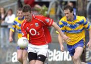 3 July 2004; Derek Kavanagh, Cork, prepares to clear under pressure from David Russell, Clare. Bank of Ireland Football Championship Qualifier, Round 2, Clare v Cork, Cusack Park, Ennis, Co. Clare. Picture credit; Ray McManus / SPORTSFILE